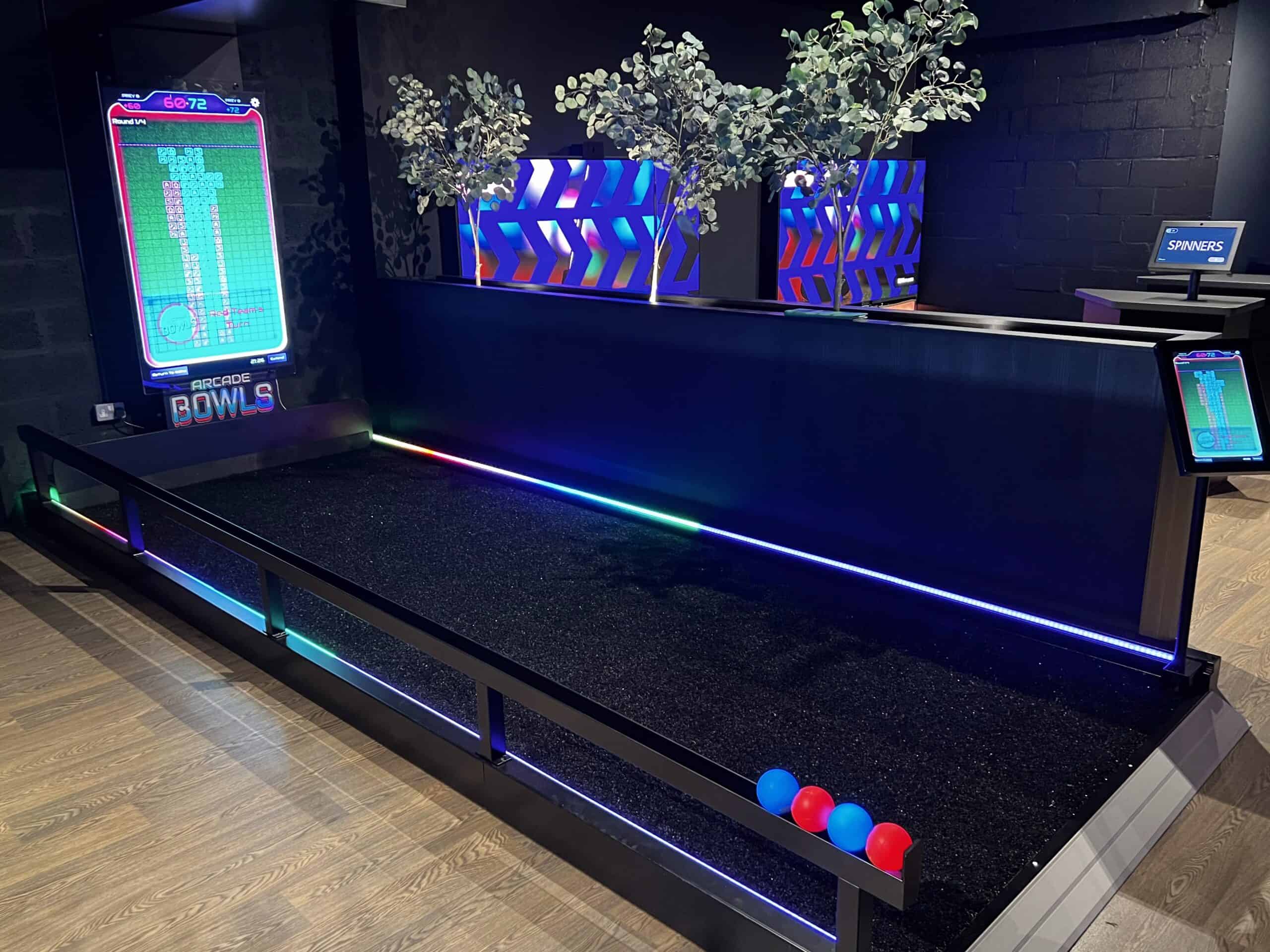 Players rolling glowing LED balls on the Electric Boules court at Spinners